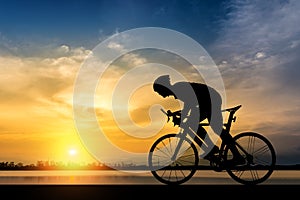 Silhouette of man ride a bicycle in sunset background