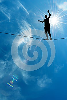 Silhouette of man on the rope concept of risk taking and challenge photo