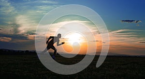 Silhouette man running on meadow