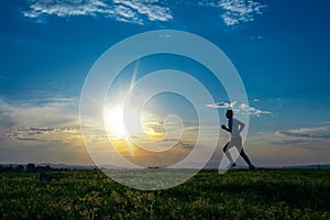 Silhouette man running on meadow