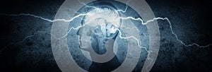 Silhouette of a man`s head with x-rayed head and lightning coming out of the brain. Conceptual idea and symbol of the work of the