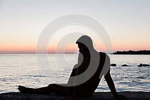 Silhouette of a man by the sea in sunset