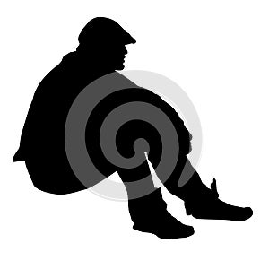 Silhouette of a man sitting on the ground