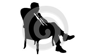 Silhouette of a man sitting in a modern armchair