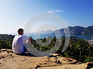 Silhouette man sitting on the top of mountain