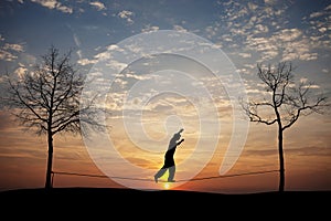 Silhouette of man on slackline