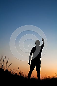 Silhouette of man standing in field