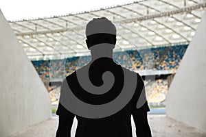 Silhouette of a man standing at the stadium