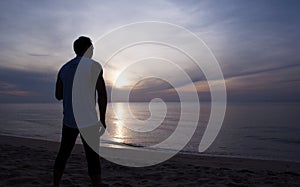 Silhouette Man stands at Sunrise