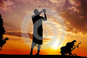 Silhouette of a man swinging