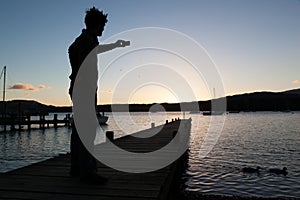 Silhouette of man taking picture with mobile phone
