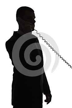 Silhouette of man talking phone