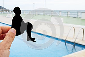 Silhouette of a man throwing himself into a pool