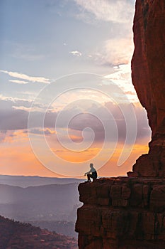 Silhouette of man on the trail at Cathedral Rock at sunset in Sedona. The colourful sunset over Sedona's Cathedral