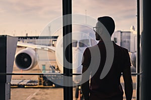 Silhouette of man waiting for his flight at airport