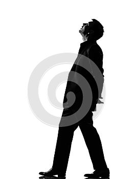 Silhouette man walking musing looking up photo