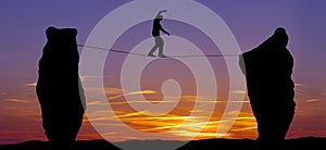 Silhouette of a man walking on the tightrope