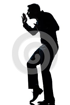 Silhouette man walking tiptoe quietly full length