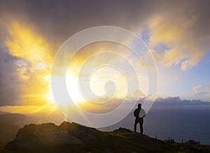 Silhouette Of Man Watching sunset Over Sea