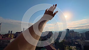 Silhouette of man is waving hand against the sunset, sunrise sky