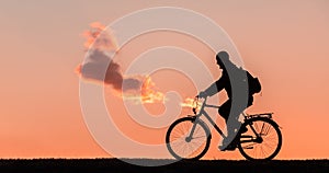 Silhouette of a man who rides a bicycle