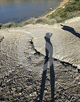 Silhouette of man and woman figure on natural grass background.Man body on a ground