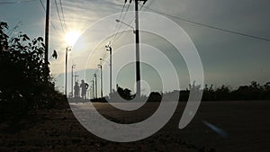 Silhouette A Man And A Woman Jogging At Sunset