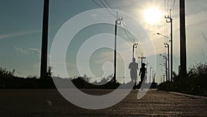 Silhouette A Man And A Woman Jogging At Sunset