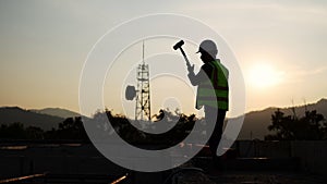 Silhouette of a man working at a construction site. Overtime labor. Work that is rushed and done on time