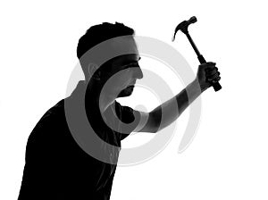 Silhouette of a man working with hammer