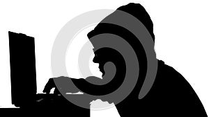 Silhouette of a man working on a laptop. Black and white mask