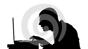 Silhouette of a man working on a laptop. Black and white mask