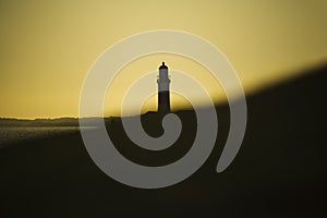 Silhouette of a maritime lighthouse against the sunset