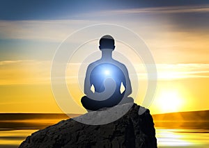 Silhouette of the meditating person