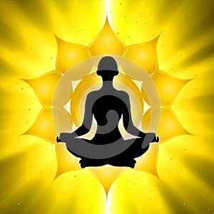 Silhouette of meditating person with Solar plexus chakra symbol background