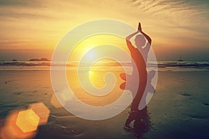 Silhouette meditation female yoga of sunset sea.