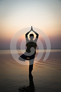 Silhouette meditation girl on the background of the stunning sea