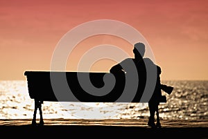 Silhouette of men sitting alone on the bench