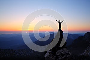 Silhouette of men on top of the mountain