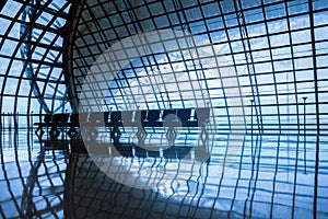 Silhouette metal structure of modern building architecture and empty waiting chairs with morning sunlight similar to spaceship