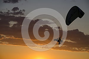 Silhouette of an microlight flying