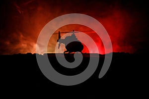 Silhouette of military helicopter ready to fly from conflict zone. Decorated night footage with helicopter starting in desert with