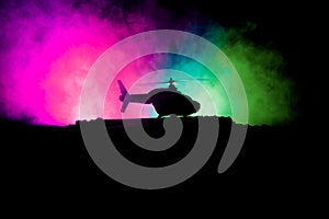 Silhouette of military helicopter ready to fly from conflict zone. Decorated night footage with helicopter starting in desert with