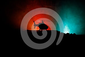 Silhouette of military helicopter ready to fly from conflict zone. Decorated night footage with helicopter starting in desert with