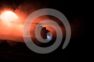 Silhouette of military helicopter ready to fly from conflict zone. Decorated night footage with helicopter starting in desert with