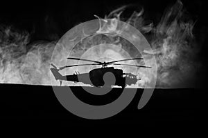 Silhouette of military helicopter ready to fly from conflict zone. Decorated night footage with helicopter starting in desert with