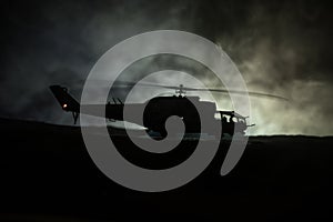 Silhouette of military helicopter ready to fly from conflict zone. Decorated night footage with helicopter starting in desert with