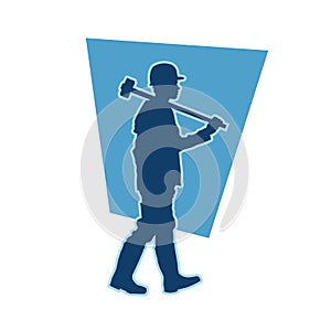 silhouette of a miner worker bringing his sledge hammer.