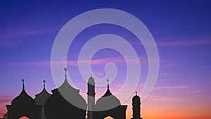 Silhouette Mosque domes with towers against colorful dramatic twilight sky background in evening time