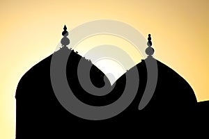 Silhouette of a mosque in the sunset sky